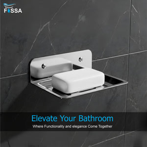 Wall-mounted soap dish with a bar of soap on a dark tiled wall, featuring the FOSSA brand.