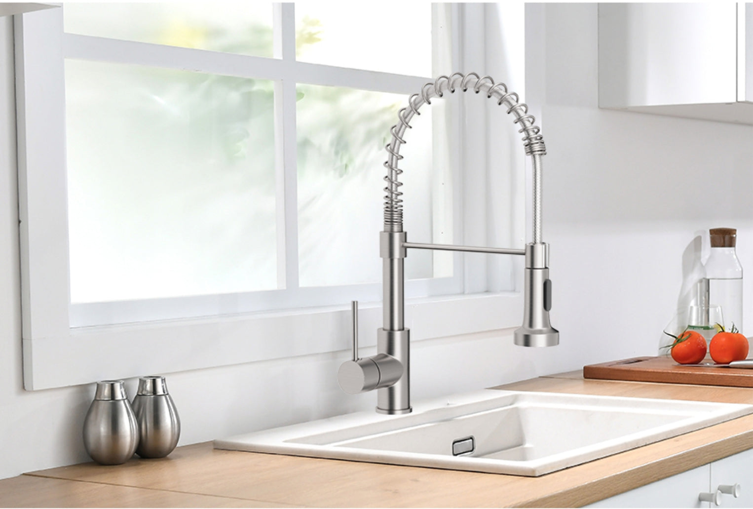 Modern kitchen sink with a stainless steel faucet in a bright room.