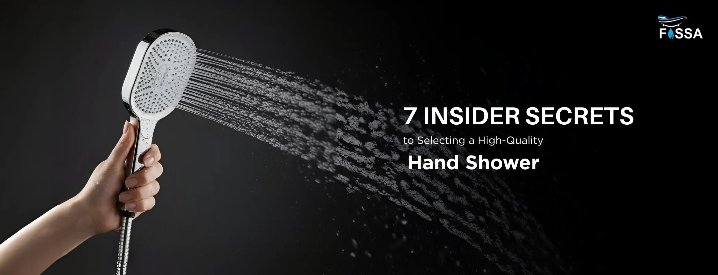 Hand holding a chrome hand shower spraying water with black background, bathroom accessory