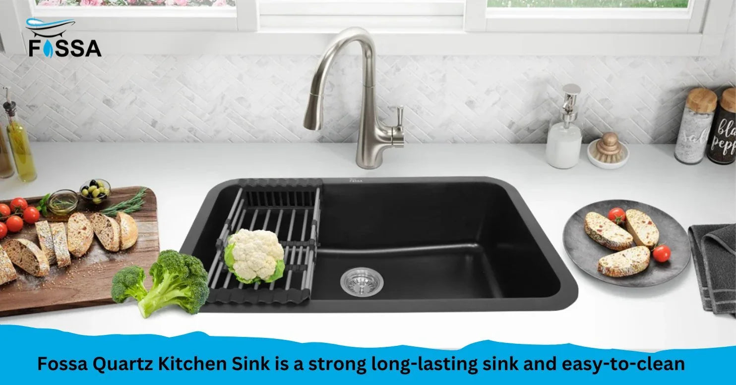 Black quartz kitchen sink with modern faucet, surrounded by bread, vegetables, and clean countertop