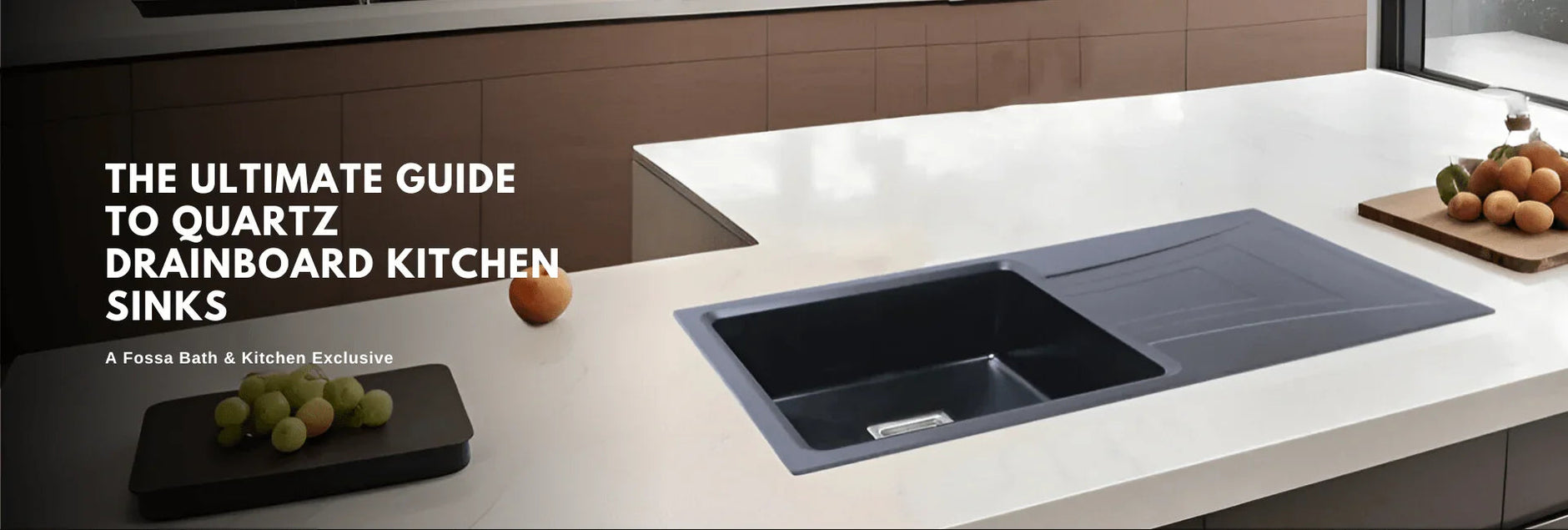 Modern kitchen with black quartz drainboard sink on white countertop, fresh fruit nearby