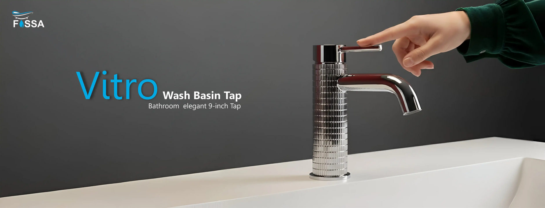 Modern chrome wash basin tap with textured cylindrical design in a bathroom setting.