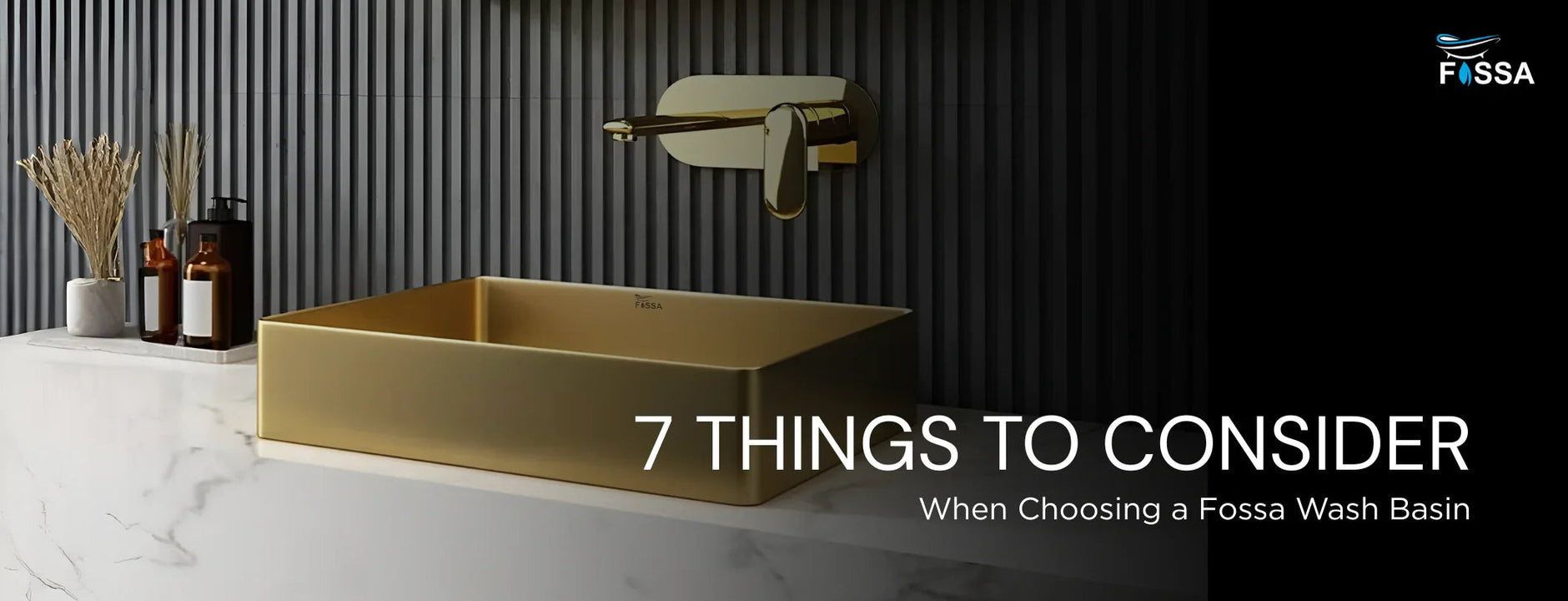 Modern gold wash basin with wall-mounted faucet on marble counter, bathroom accessories and decorative plants