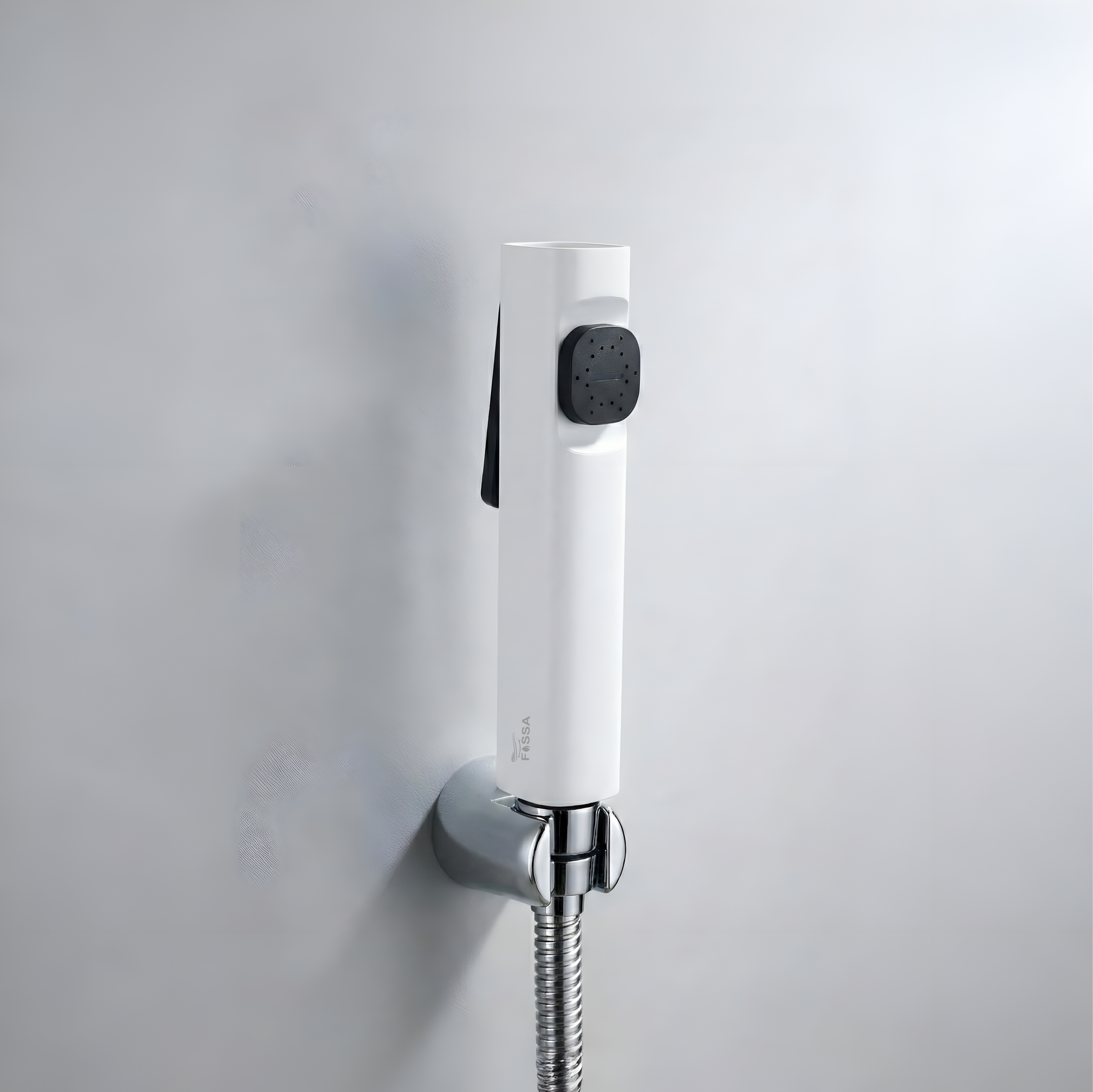 White shower head with flexible hose mounted on a gray wall