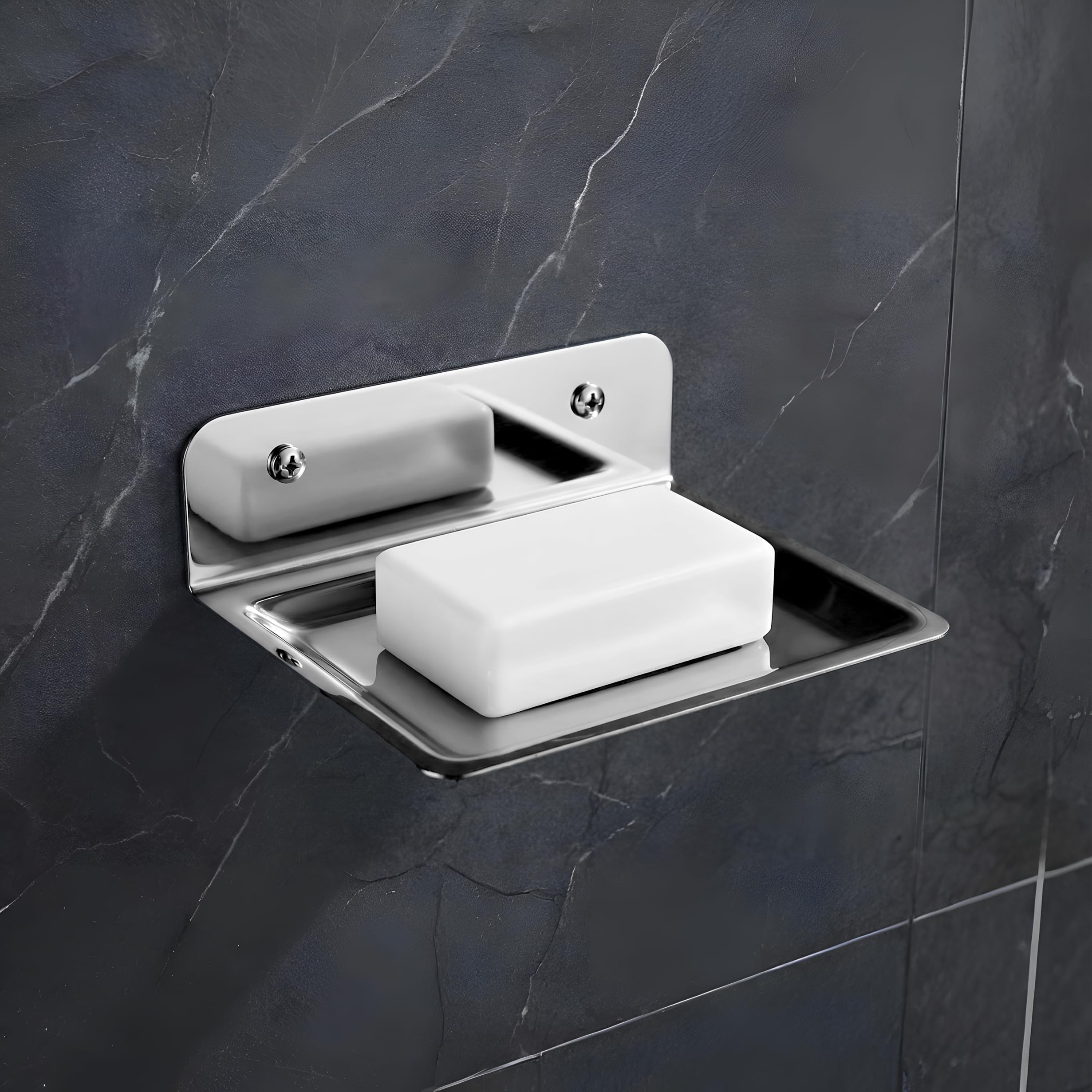 Wall-mounted soap dish with a bar of soap on a dark tiled wall
