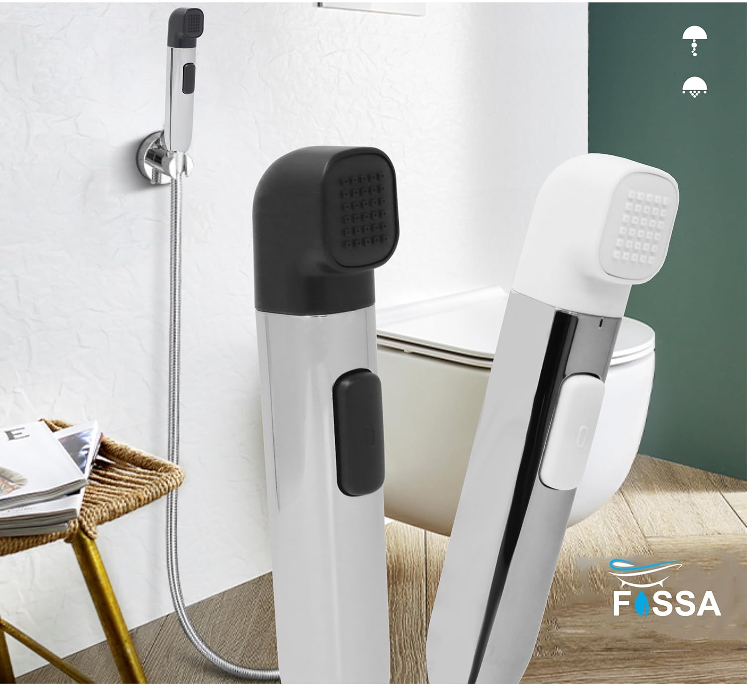Two handheld showerheads, one black and one white, on a bathroom floor with a toilet in the background.